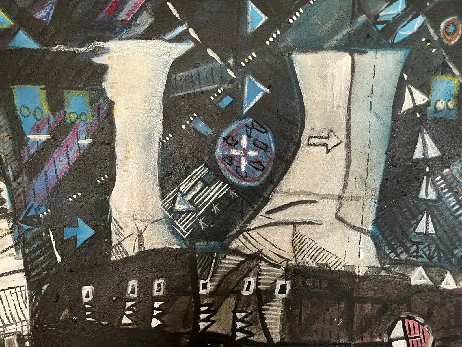 Detail — pale towers and a clock-like wheel in blue night