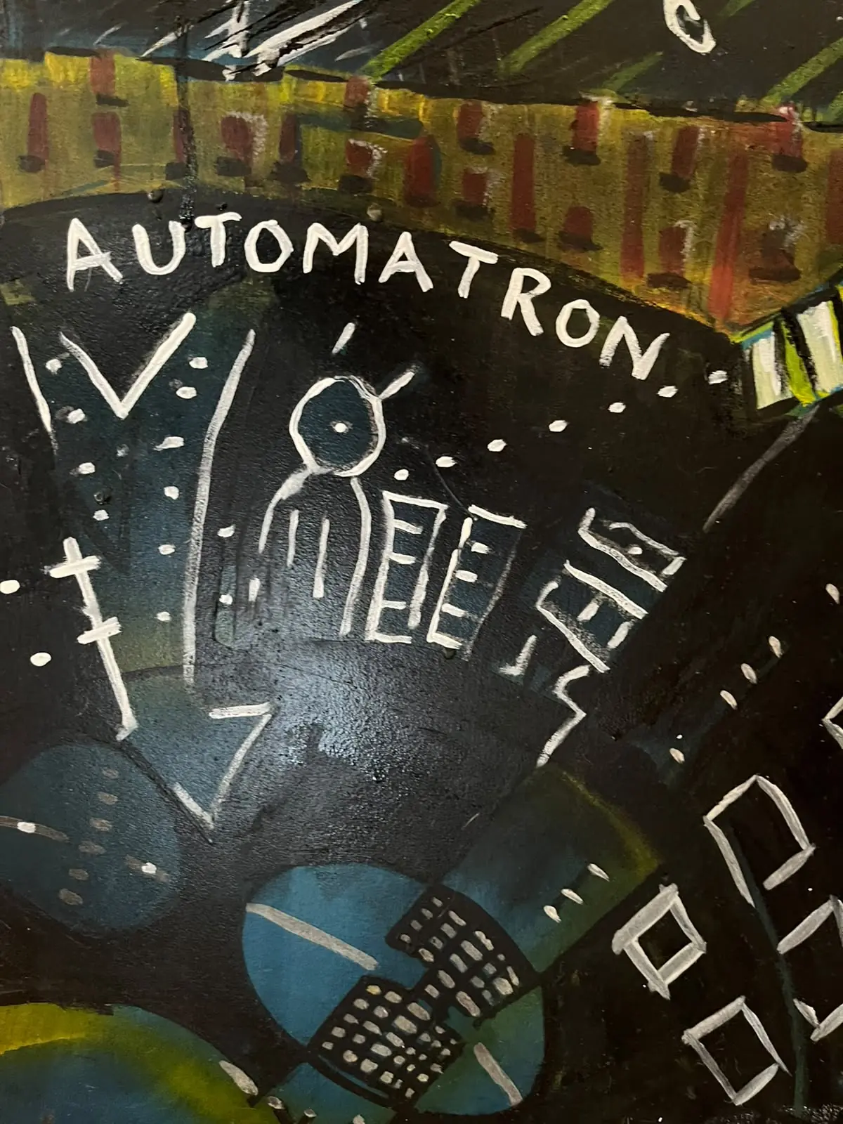 Detail — figure beneath the word Automatron